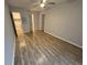 Primary bedroom with wood-look floors and access to bathroom and closet at 5380 4Th N St # 203, St Petersburg, FL 33703