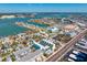 Aerial view of a community with vibrant waterfront homes, a tranquil bay, and lush green landscape at 15405 Gulf Blvd # B1, Madeira Beach, FL 33708