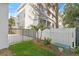 This fenced backyard offers a grassy area with well-maintained landscaping at 15405 Gulf Blvd # B1, Madeira Beach, FL 33708