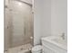 Modern bathroom featuring a glass-enclosed shower with white vanity and quartz countertop at 15405 Gulf Blvd # B1, Madeira Beach, FL 33708