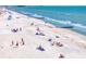 Picturesque beach scene with sunbathers enjoying the sun and the calm ocean waves at 15405 Gulf Blvd # B1, Madeira Beach, FL 33708