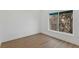 Bedroom showcasing wood floors, light walls, trim, and a large window at 15405 Gulf Blvd # B1, Madeira Beach, FL 33708