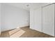 Bedroom featuring wood floors, neutral walls, and a large closet with sliding doors at 15405 Gulf Blvd # B1, Madeira Beach, FL 33708