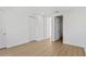 Bedroom featuring wood floors, white walls, and multiple closets at 15405 Gulf Blvd # B1, Madeira Beach, FL 33708