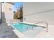 Inviting rectangular pool with a calming spa area, metal railing, and modern pool tile at 15405 Gulf Blvd # B1, Madeira Beach, FL 33708