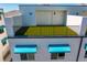 The private rooftop terrace features artifical turf and a secure black metal railing at 15405 Gulf Blvd # B1, Madeira Beach, FL 33708