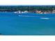 Panoramic view of the calm bay with waterfront homes, lush trees, and a boat creating a mesmerizing scene at 15405 Gulf Blvd # B1, Madeira Beach, FL 33708