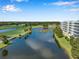 Scenic aerial view of the community featuring a serene lake and lush golf course, offering a picturesque setting at 1200 Country Club Dr # 6103, Largo, FL 33771