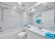 Bathroom with a tub and shower combination, a large mirror, and a modern toilet and sink at 1200 Country Club Dr # 6103, Largo, FL 33771