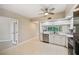 Open concept kitchen with tile floors, white cabinets, stainless steel appliances, and natural light creates inviting space at 1200 Country Club Dr # 6103, Largo, FL 33771