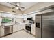 Modern kitchen features stainless steel appliances, white cabinets, and a view from the window for a bright atmosphere at 1200 Country Club Dr # 6103, Largo, FL 33771