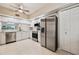 Bright kitchen features white cabinets, stainless steel appliances, and a ceiling fan for a modern and functional space at 1200 Country Club Dr # 6103, Largo, FL 33771