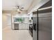 Well-lit kitchen with stainless steel refrigerator and appliances with white cabinetry against a light tile floor at 1200 Country Club Dr # 6103, Largo, FL 33771