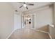 Bright living room with white walls, wood floors, and sliding doors leading to the kitchen at 1200 Country Club Dr # 6103, Largo, FL 33771