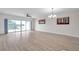 Spacious living room featuring wood floors, a ceiling fan, and sliding doors to a balcony with scenic views at 1200 Country Club Dr # 6103, Largo, FL 33771