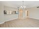 Open-concept living room with wood floors and a view of the adjacent kitchen, creating a bright and airy space at 1200 Country Club Dr # 6103, Largo, FL 33771