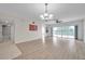 Bright living room with wood floors, chandelier lighting, and sliding glass doors leading to the balcony at 1200 Country Club Dr # 6103, Largo, FL 33771