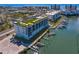 Aerial view of a modern apartment with rooftop green space, pool, and boat docks at 400 150Th Ave # 302, Madeira Beach, FL 33708
