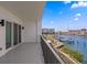 Expansive balcony view overlooking the marina, boats, pool, and waterways on a sunny day at 400 150Th Ave # 302, Madeira Beach, FL 33708