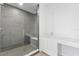 Modern bathroom featuring walk-in shower with gray tile, bench and sleek vanity at 400 150Th Ave # 302, Madeira Beach, FL 33708