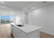Kitchen island with stainless steel sink in a bright modern home at 400 150Th Ave # 302, Madeira Beach, FL 33708