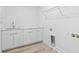 Bright laundry room featuring sleek cabinets, countertop space, and modern fixtures at 400 150Th Ave # 302, Madeira Beach, FL 33708