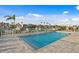 Community pool overlooking the marina featuring lounge chairs, palm trees, and beautiful waterfront views at 400 150Th Ave # 302, Madeira Beach, FL 33708