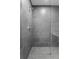 Modern shower featuring gray tile, a glass door and matching flooring at 400 150Th Ave # 302, Madeira Beach, FL 33708