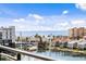 Beautiful waterfront view of the marina from the condo featuring blue skies, palm trees, and various building at 400 150Th Ave # 302, Madeira Beach, FL 33708