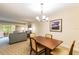 Dining area with wood table and chairs, view into living room at 36750 Us Highway 19 N # 21305, Palm Harbor, FL 34684