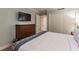 King-size bed in a well-lit bedroom with wood furniture and blue accents at 36750 Us Highway 19 N # 21305, Palm Harbor, FL 34684