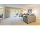 Bright living room featuring a sectional sofa and sliding glass doors leading to a balcony at 36750 Us Highway 19 N # 21305, Palm Harbor, FL 34684