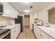 Modern kitchen with white cabinets, stainless steel appliances, and quartz countertops at 36750 Us Highway 19 N # 21305, Palm Harbor, FL 34684