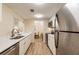 Modern kitchen with white cabinets, stainless steel appliances, and quartz countertops at 36750 Us Highway 19 N # 21305, Palm Harbor, FL 34684