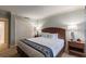 King-size bed in a well-lit bedroom with wood furniture and blue accents at 36750 Us Highway 19 N # 21305, Palm Harbor, FL 34684