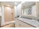 Bathroom with shower, toilet, granite vanity, and large mirror at 36750 Us Highway 19 N # 21305, Palm Harbor, FL 34684