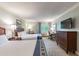 Bedroom with two double beds, dresser, and TV at 36750 Us Highway 19 N # 21305, Palm Harbor, FL 34684