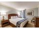 King-size bed in a well-lit bedroom with wood furniture and blue accents at 36750 Us Highway 19 N # 21305, Palm Harbor, FL 34684