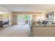 Bright living room featuring a sectional sofa and sliding glass doors leading to a balcony at 36750 Us Highway 19 N # 21305, Palm Harbor, FL 34684