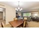 Bright dining area with a wood table and four chairs, view of living room and kitchen at 36750 Us Highway 19 N # 21305, Palm Harbor, FL 34684