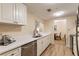 Modern kitchen with white cabinets, stainless steel appliances, and quartz countertops at 36750 Us Highway 19 N # 21305, Palm Harbor, FL 34684