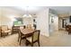 Bright dining area with a wood table and chairs, adjacent to the kitchen at 36750 Us Highway 19 N # 21305, Palm Harbor, FL 34684