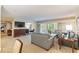 Open living space with ample seating, a large TV, and views of the balcony at 36750 Us Highway 19 N # 21305, Palm Harbor, FL 34684