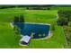 Serene pond with screened pavilion; lush landscape at 33642 Blanton Rd, Dade City, FL 33523
