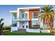 Stunning modern home with a combination of white, wood grain, and glass elements, and a well-manicured front yard at 2608 N Ridgewood Ave, Tampa, FL 33602
