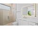 Modern bathroom with a walk-in shower, floating vanity, and LED mirror at 2608 N Ridgewood Ave, Tampa, FL 33602