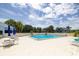 Community pool with lounge chairs and patio tables at 5940 Pelican Bay S Plz # 1204, Gulfport, FL 33707