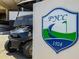 Club golf cart parked near the community logo at 5940 Pelican Bay S Plz # 1204, Gulfport, FL 33707
