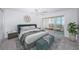 Main bedroom with access to a private balcony and water views at 622 Edgewater Dr # 822, Dunedin, FL 34698