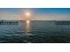 Scenic waterfront view at sunset with boats and a pier at 622 Edgewater Dr # 822, Dunedin, FL 34698